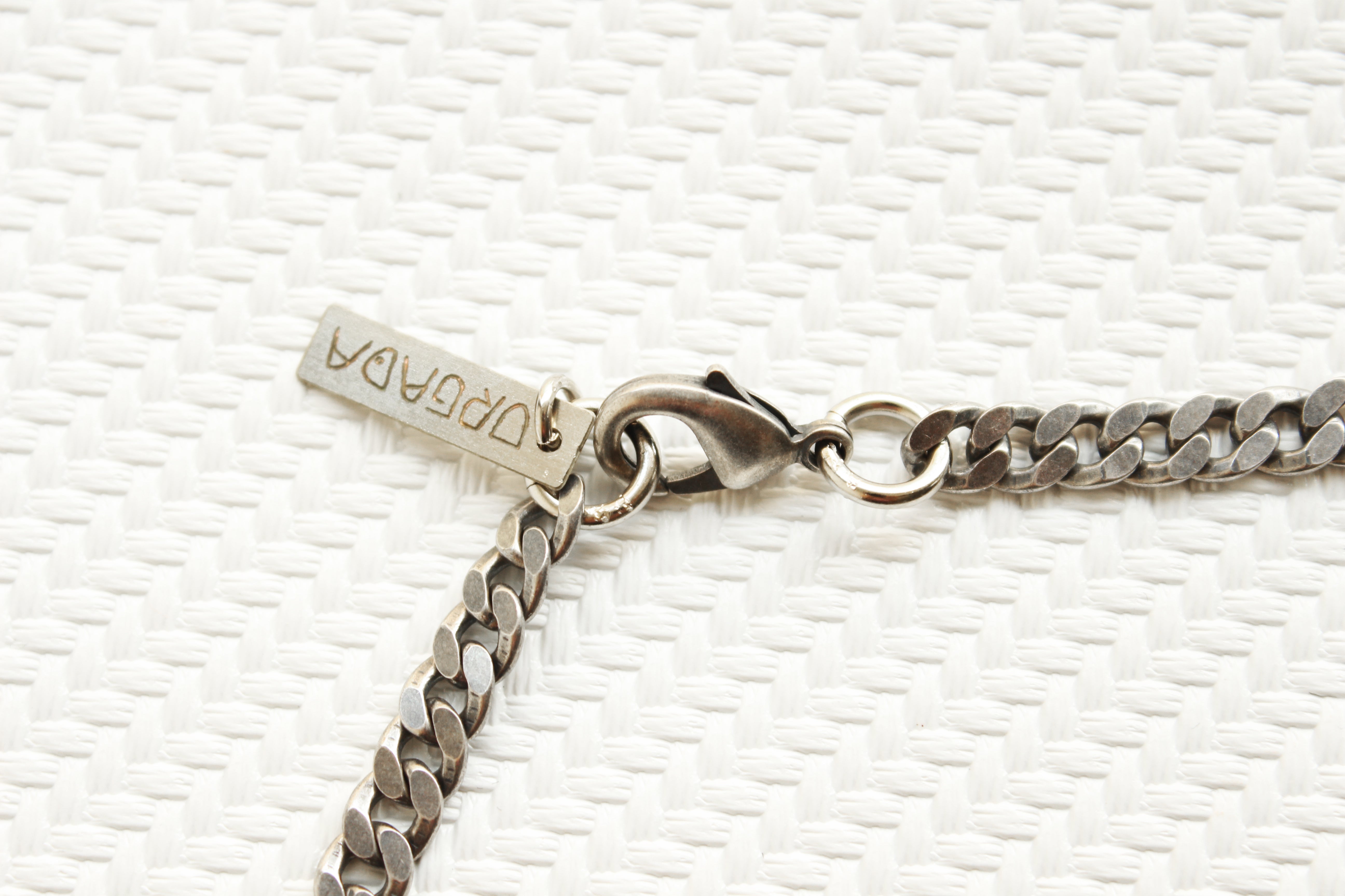 ORGADA'S Hieroglyph Queen necklace and a lobster clasp closure in close-up