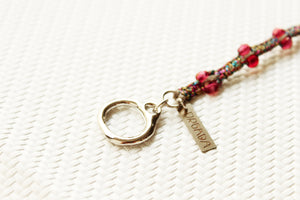 ORGADA's Bullia bracelet made of colourful waxed cords and a bull pendant in a macrame tecnique photographed in close-up