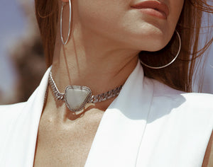 a model is modelling Orgada's Moonstone Pariteet Choker designed for the ultimate bohemian princess at the beach