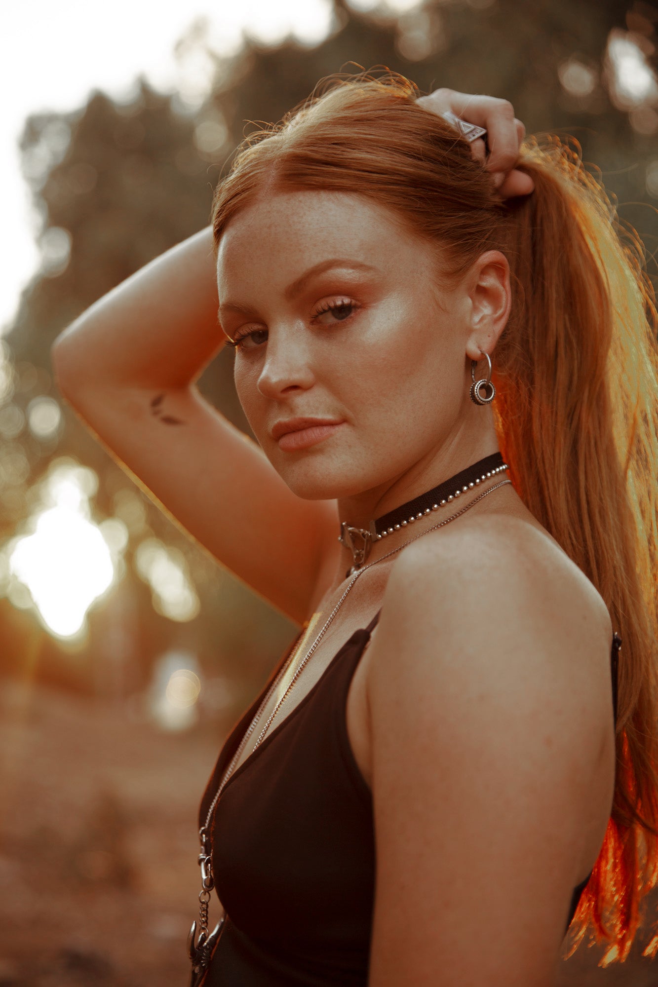 an edgy model modelling orgada's black grungy and sexy Spot Choker in the woods