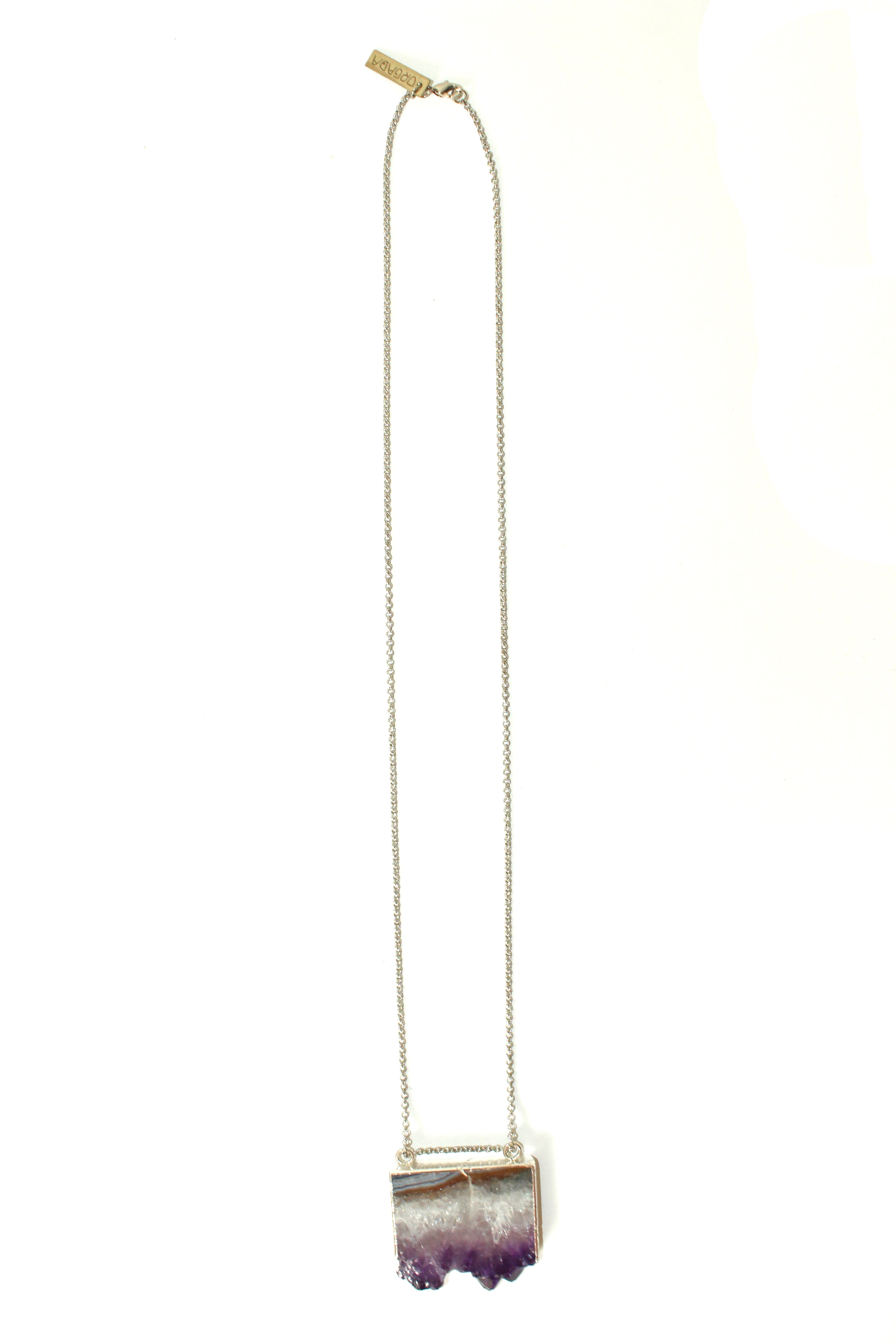 Orgada's boho Orka necklace, designed with a precious Amethyst stone and is related to the third eye chakra, on a white background 