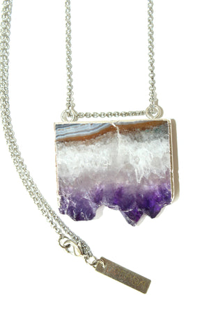 Orgada's boho Orka necklace, designed with a precious Amethyst stone and is related to the third eye chakra, on a white background